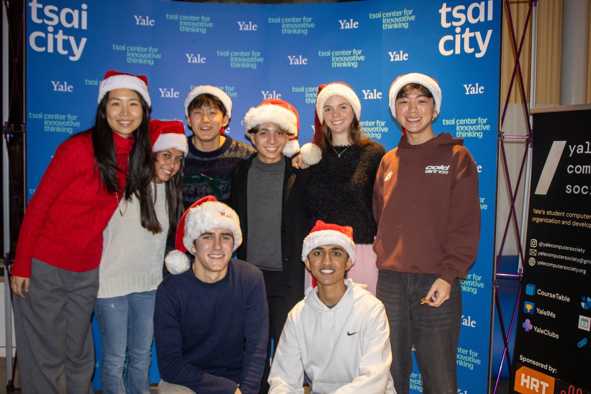 Members in Santa hats at the holiday Demo Day